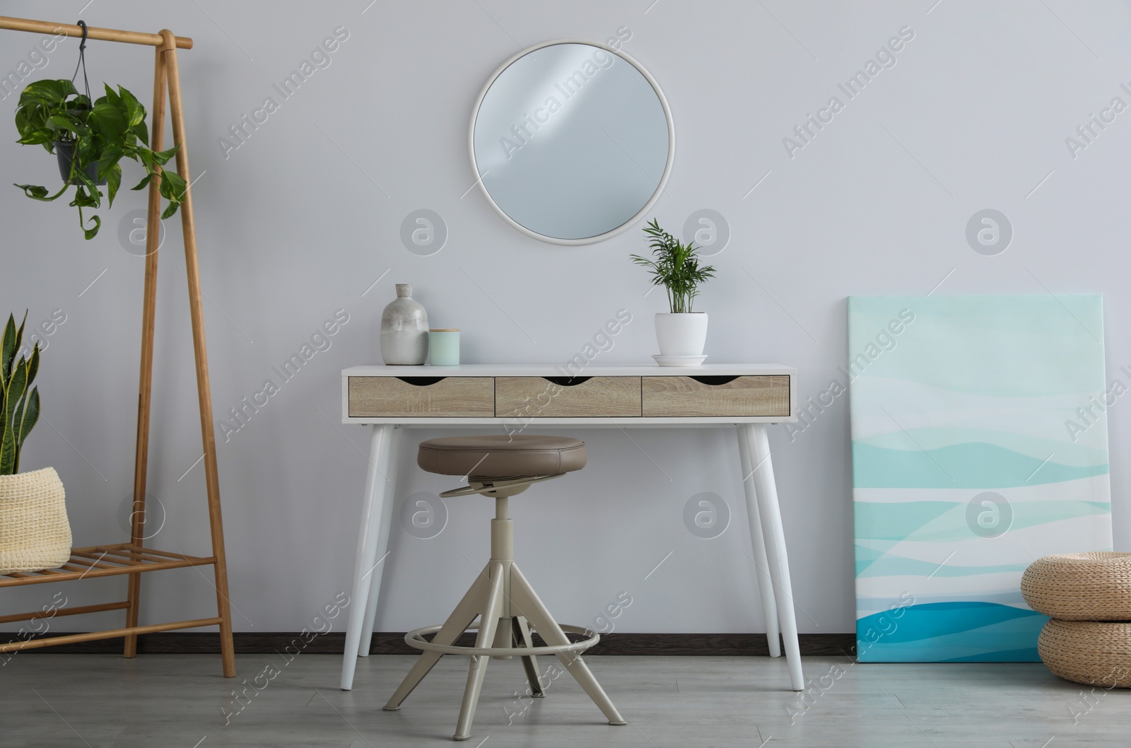 Photo of Stylish room interior with round mirror on wall over console table