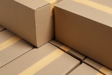 Photo of Many closed cardboard boxes as background. Packaging goods