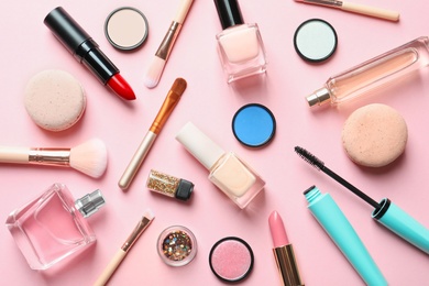 Photo of Flat lay composition with decorative cosmetics on color background