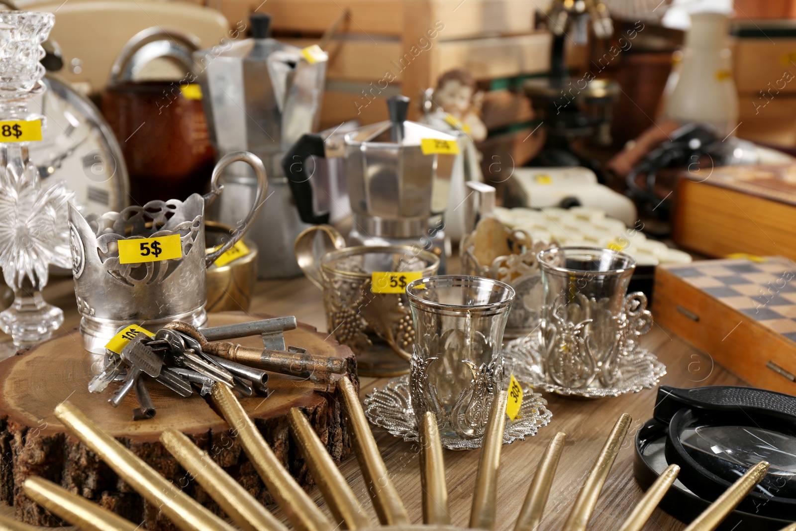 Photo of Many different items on wooden table. Garage sale