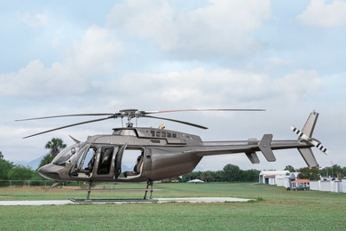 Photo of Beautiful modern helicopter on helipad in field