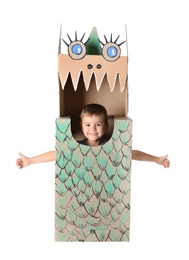 Photo of Cute little boy playing with cardboard dragon on white background