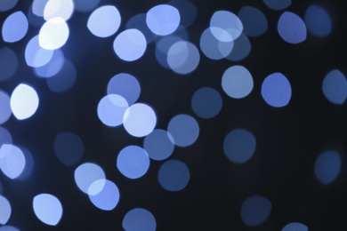 Blurred view of beautiful lights on dark background