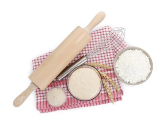 Photo of Leaven, flour, rolling pin, whisk and ears of wheat isolated on white, top view