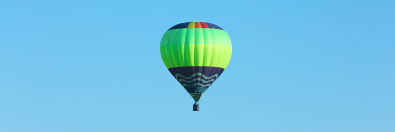 Hot air balloon in blue sky. Banner design 