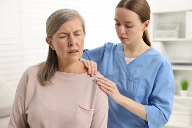 Photo of Arthritis symptoms. Doctor examining patient with shoulder pain in hospital