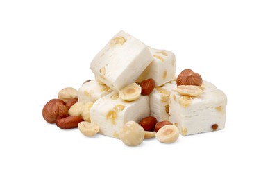 Photo of Pieces of delicious nougat and nuts on white background