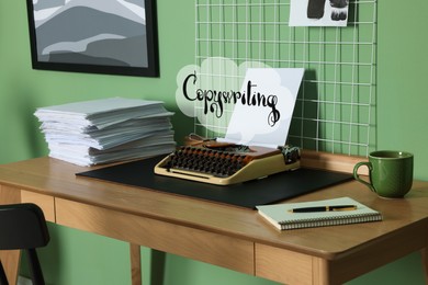 Image of Thought cloud with word Copywriting, typewriter, stack of paper, stationery and coffee. Stylish workplace with mood board