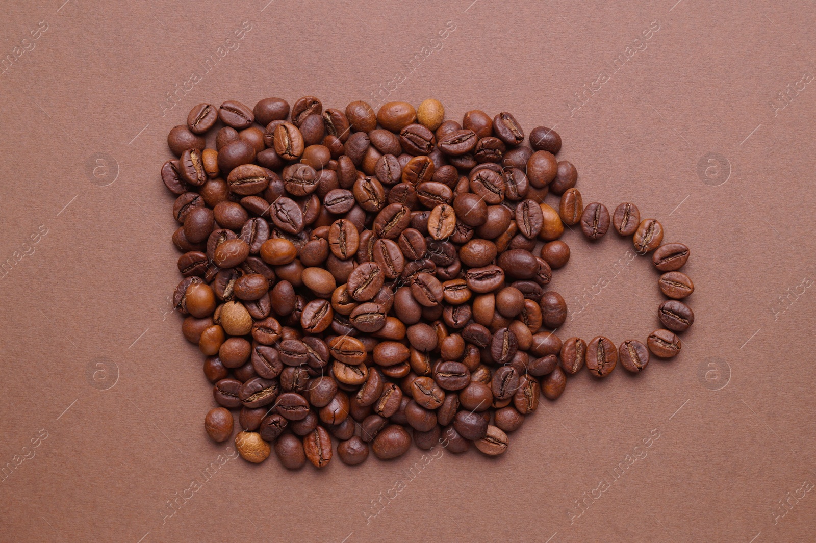 Photo of Cup of drink, composition made with coffee beans on brown background, flat lay