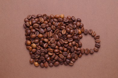 Cup of drink, composition made with coffee beans on brown background, flat lay