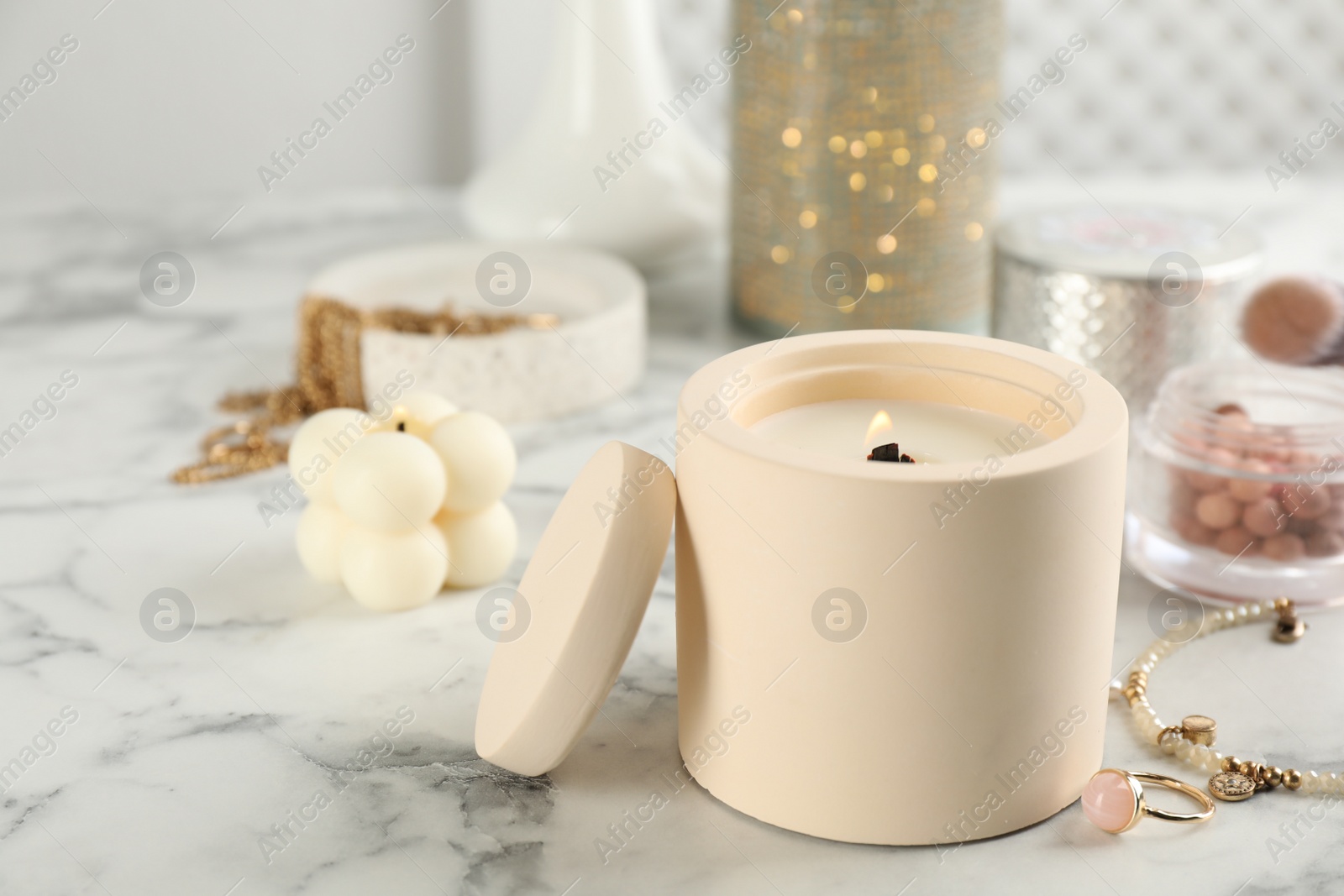 Photo of Composition with burning soy candles on white marble table, space for text