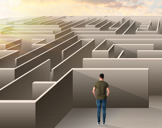 Image of Young man trying to find way out of maze