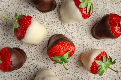 Photo of Delicious chocolate covered strawberries on light background, top view