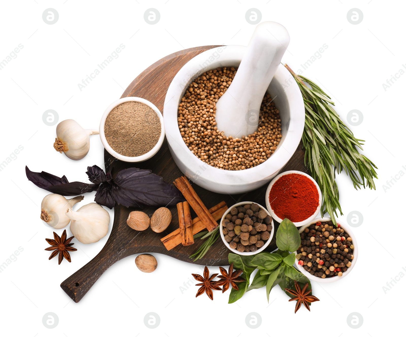 Photo of Mortar with pestle and different spices on white background, top view