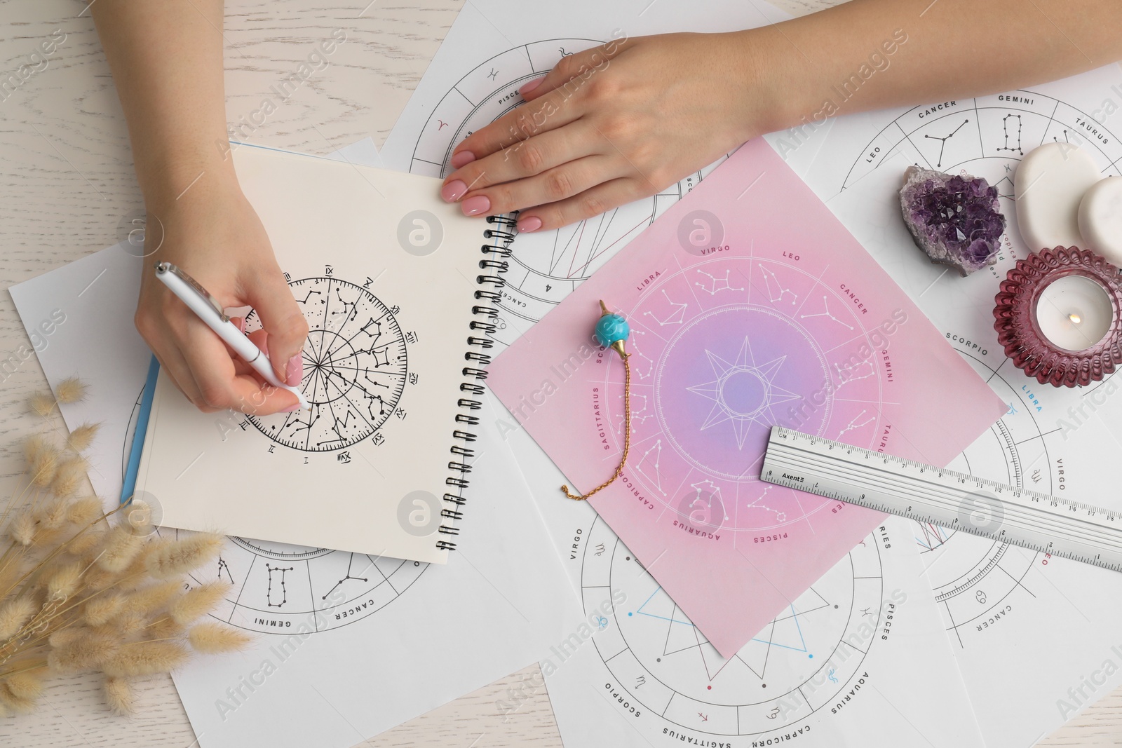 Photo of Astrologer using zodiac wheel for fate forecast at table, top view. Fortune telling