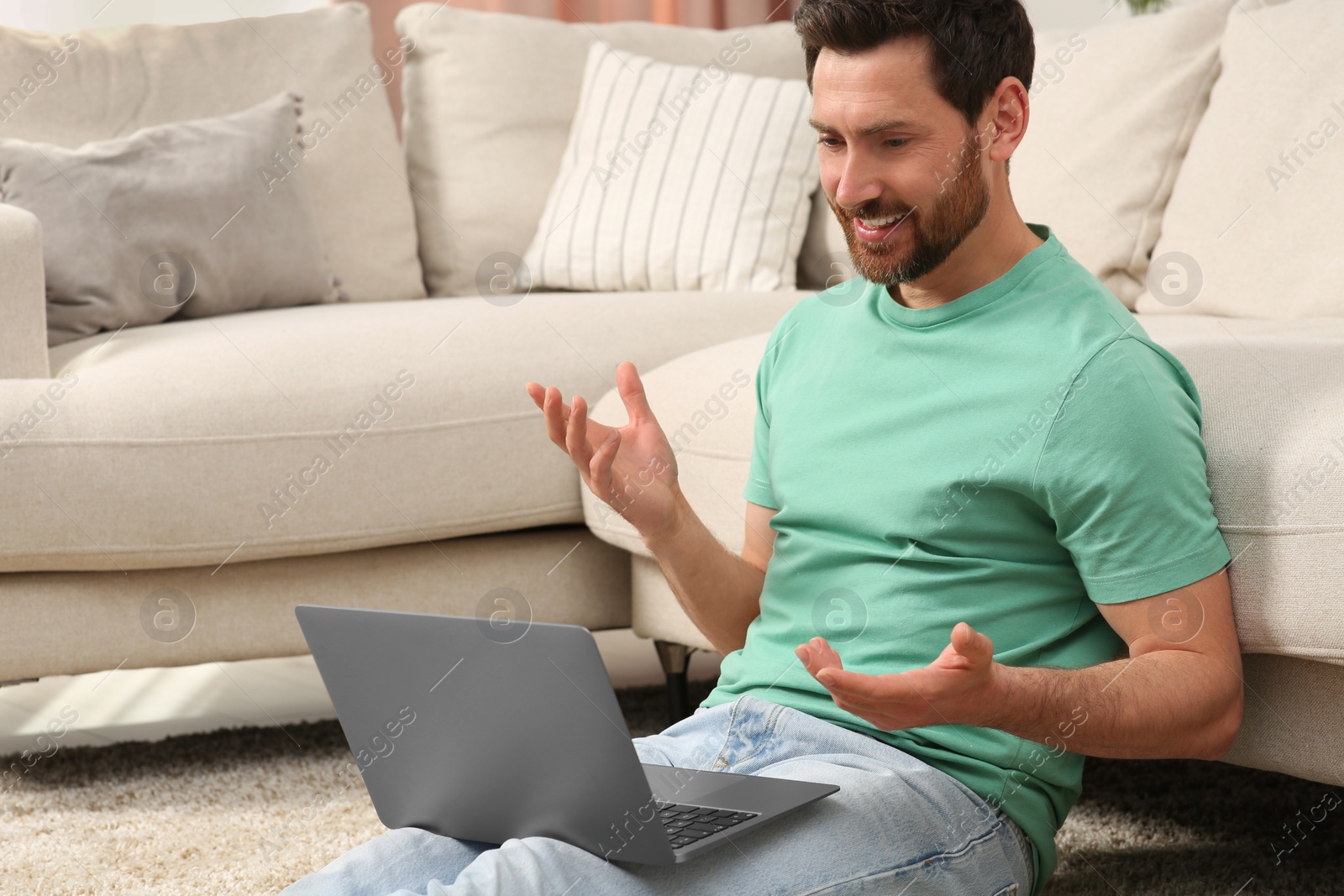 Photo of Man having video chat via laptop at home