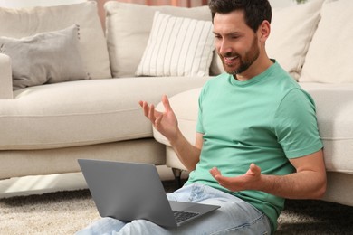 Man having video chat via laptop at home