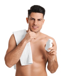 Photo of Handsome man with stubble holding post shave lotion on white background
