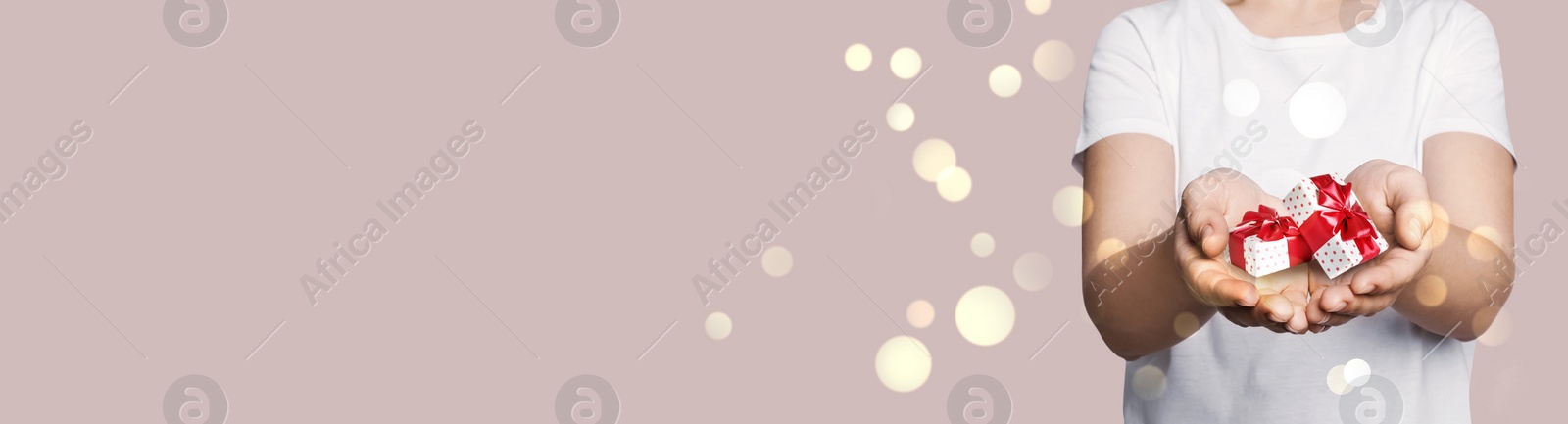 Image of Boxing day, banner design. Woman with gifts on beige background, closeup and space for text