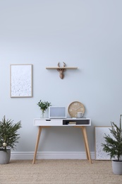 Photo of Stylish room interior with potted fir trees decorated for Christmas