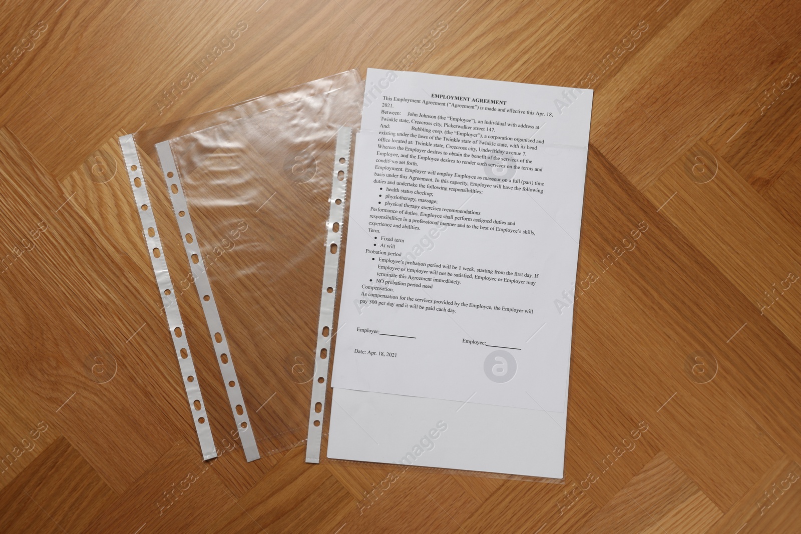 Photo of Punched pockets with document on wooden table, flat lay