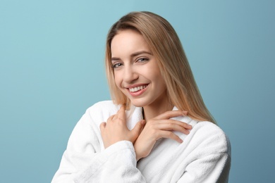 Photo of Beautiful young woman with silky skin on color background