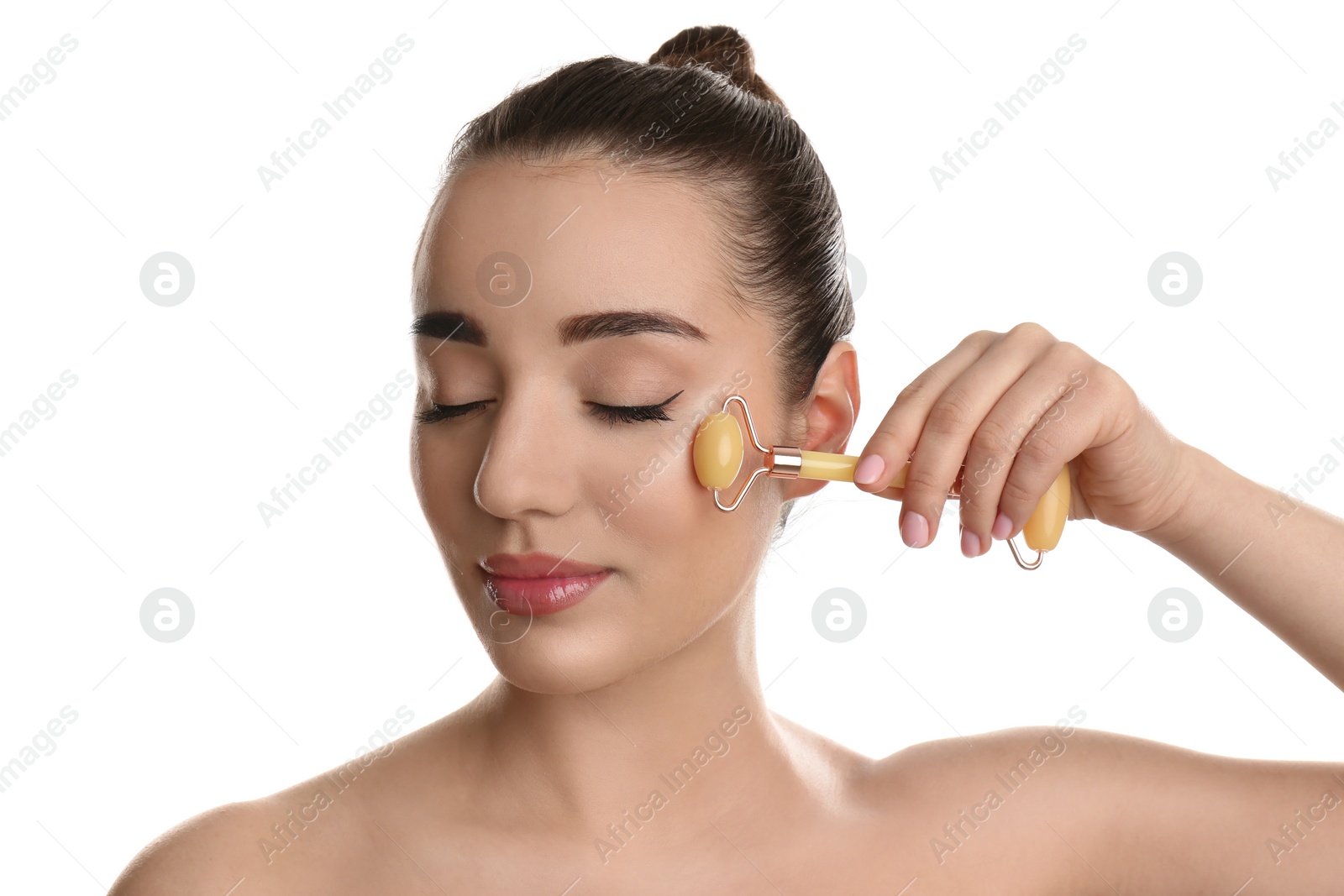 Photo of Woman using natural jade face roller on white background