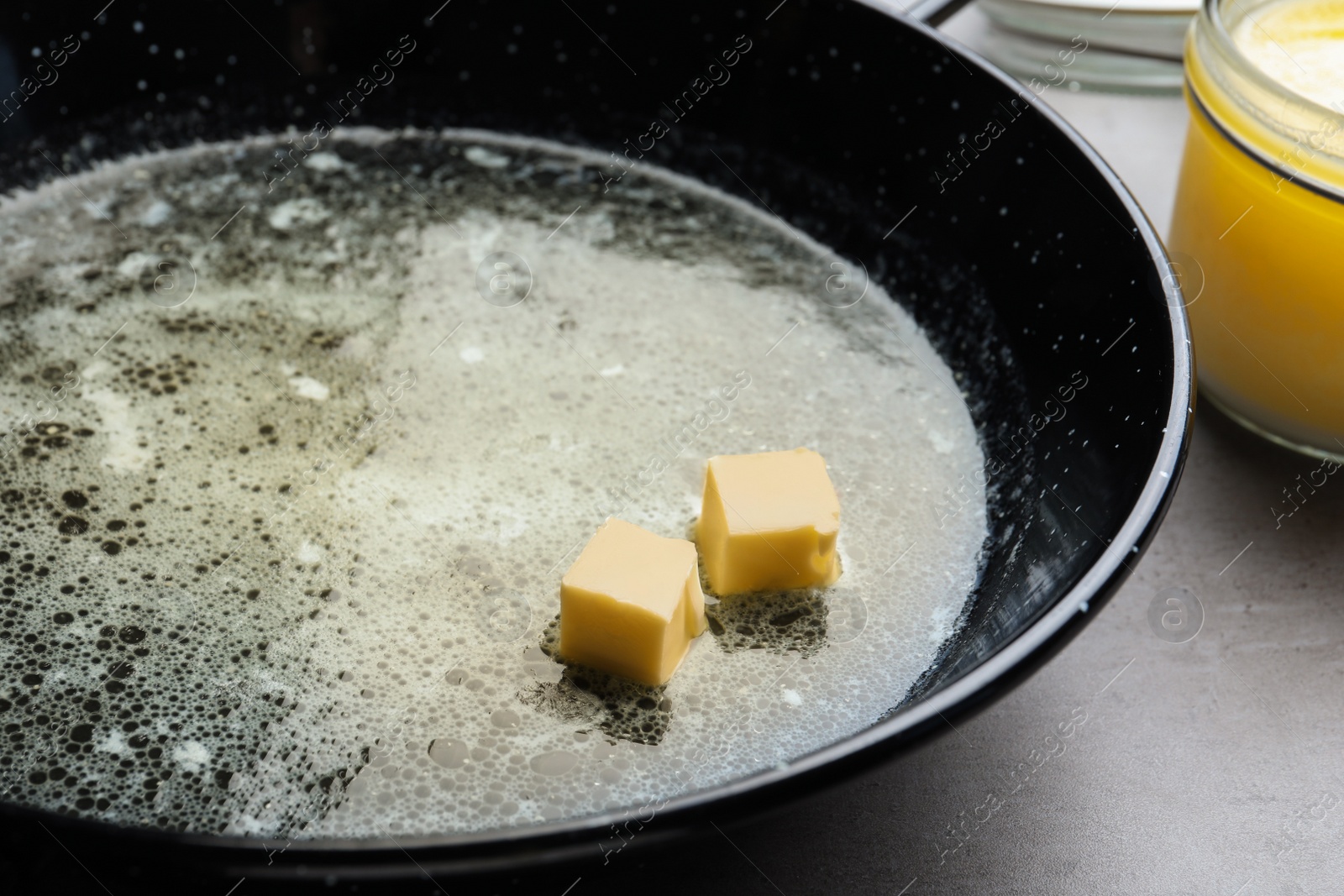 Photo of Melting butter in frying pan, closeup view