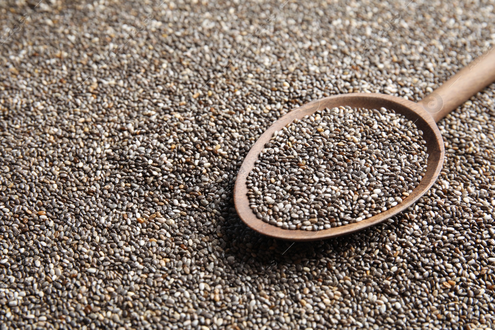 Photo of Spoon of chia seeds on grains, closeup. Space for text