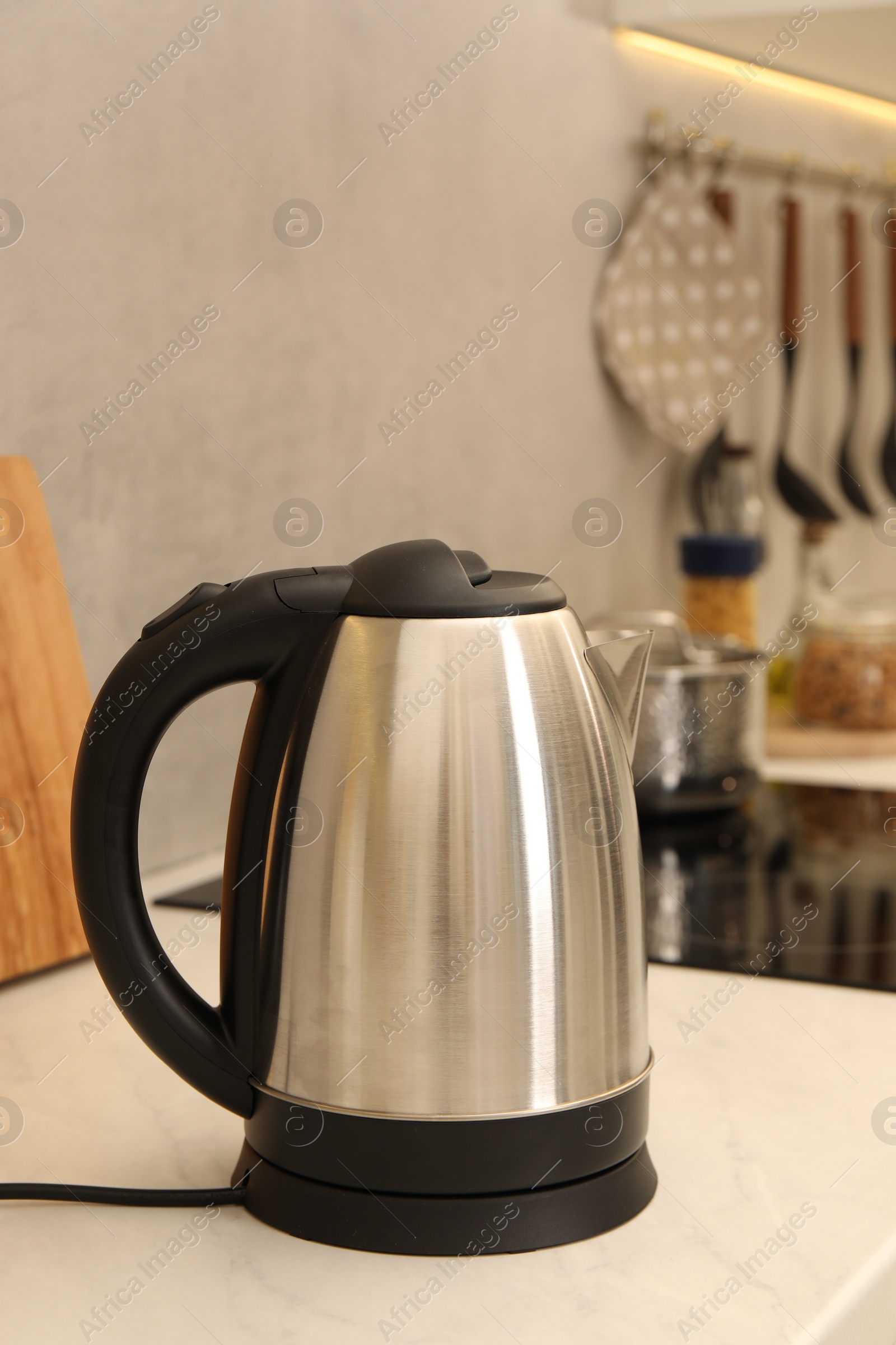 Photo of Modern electric kettle on counter in kitchen