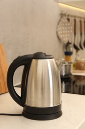 Photo of Modern electric kettle on counter in kitchen