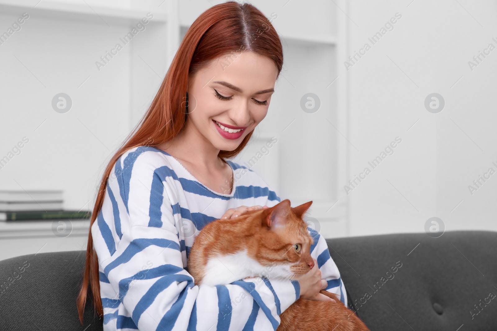 Photo of Happy woman with her cute cat at home