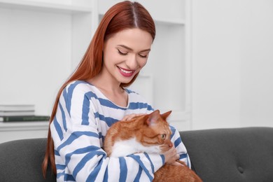 Happy woman with her cute cat at home