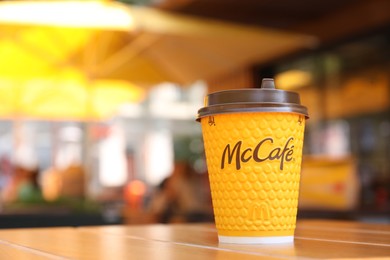 MYKOLAIV, UKRAINE - AUGUST 11, 2021: Hot McDonald's drink on table in cafe. Space for text