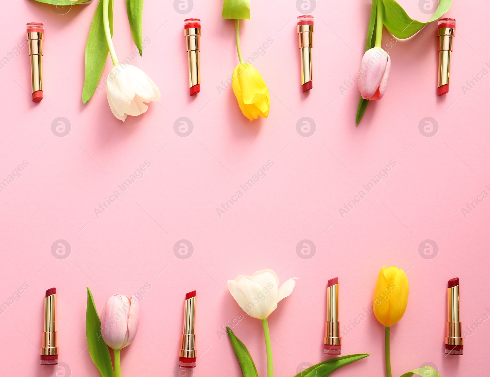Photo of Flat lay composition with different lipsticks and tulip flowers on color background, space for text