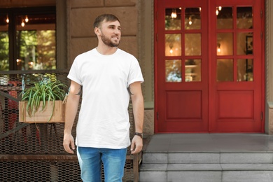 Young man wearing white t-shirt on street