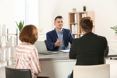 Photo of Human resources manager conducting job interview with applicants in office