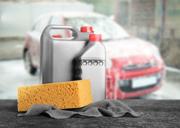 Cleaning supplies on black stone surface at car wash