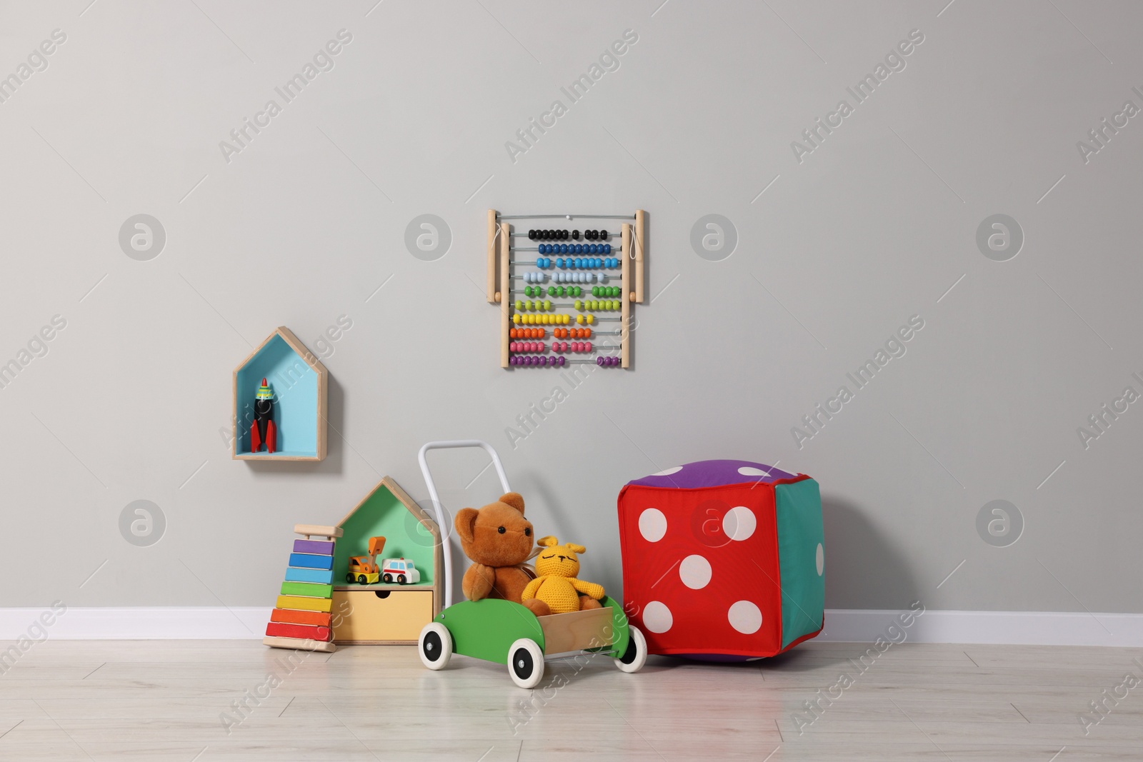 Photo of Beautiful children's room with grey wall and toys. Interior design