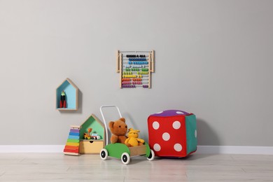 Photo of Beautiful children's room with grey wall and toys. Interior design