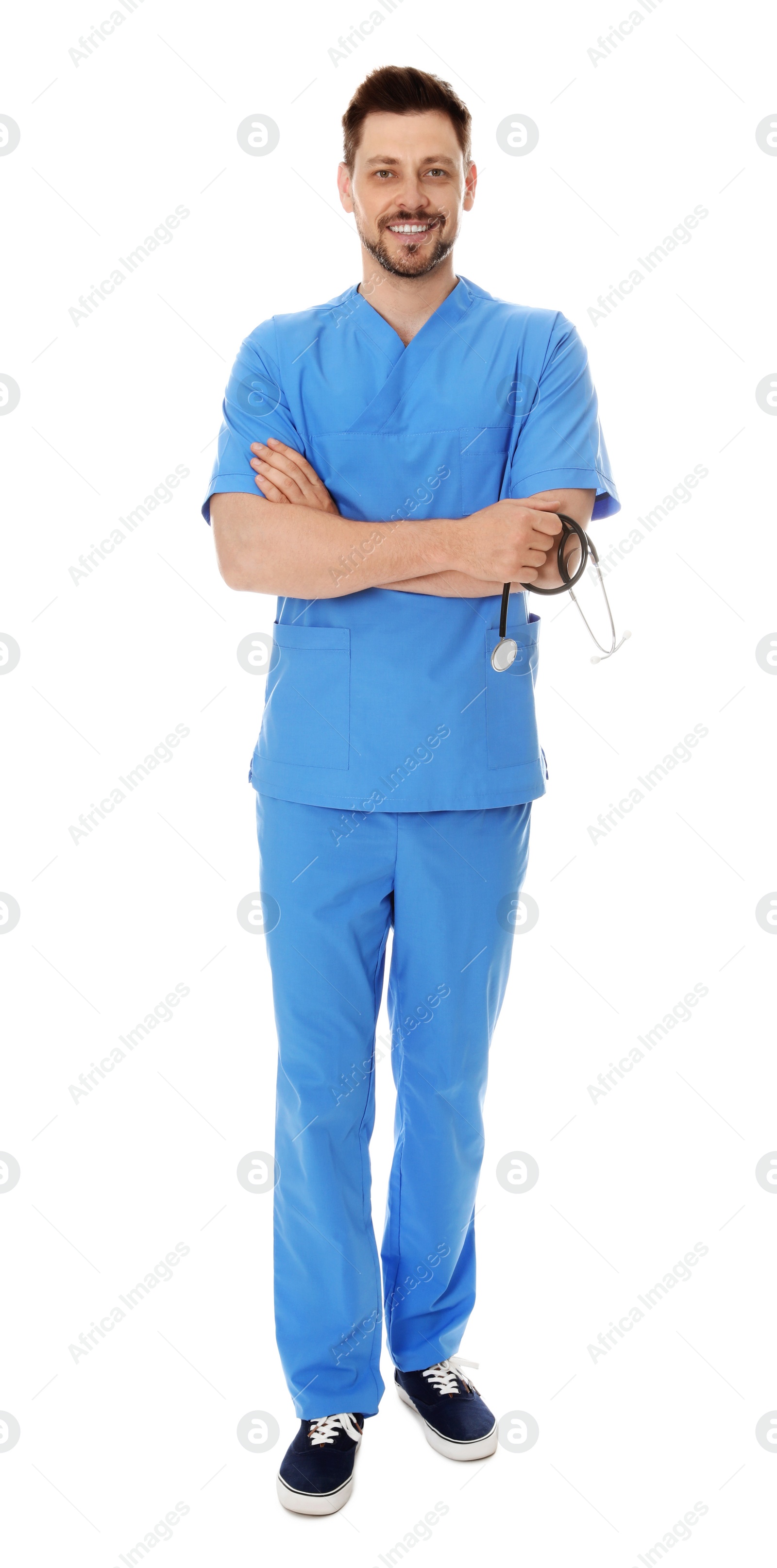 Photo of Full length portrait of smiling male doctor in scrubs isolated on white. Medical staff