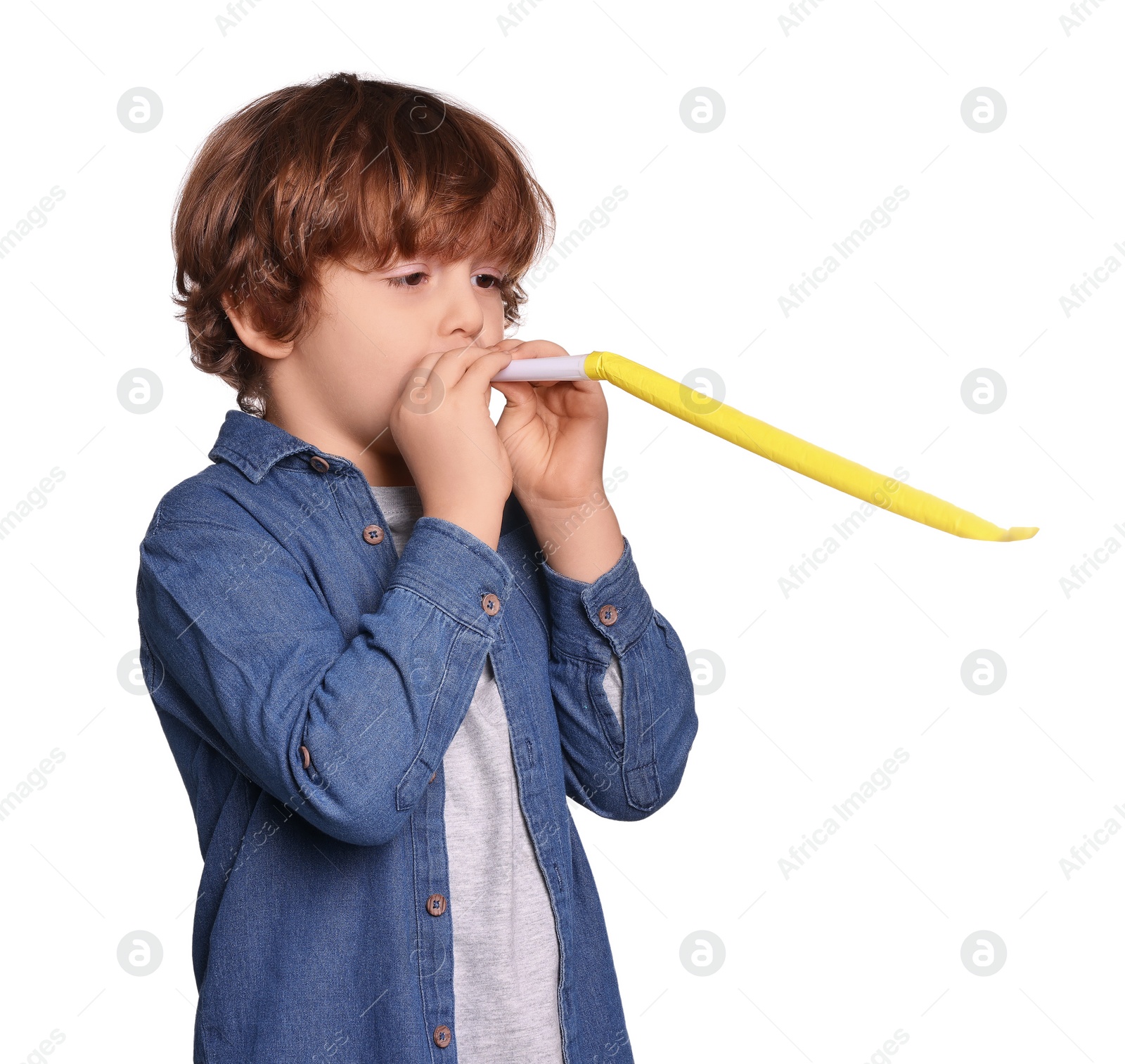 Photo of Birthday celebration. Cute little boy with blower on white background