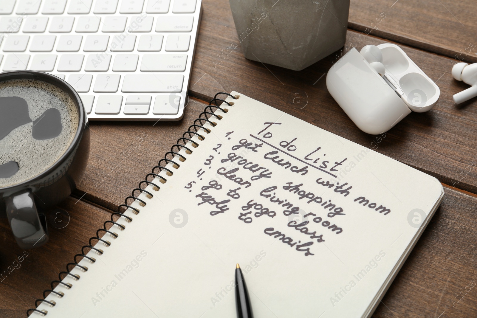 Photo of Notebook with to do list on wooden table