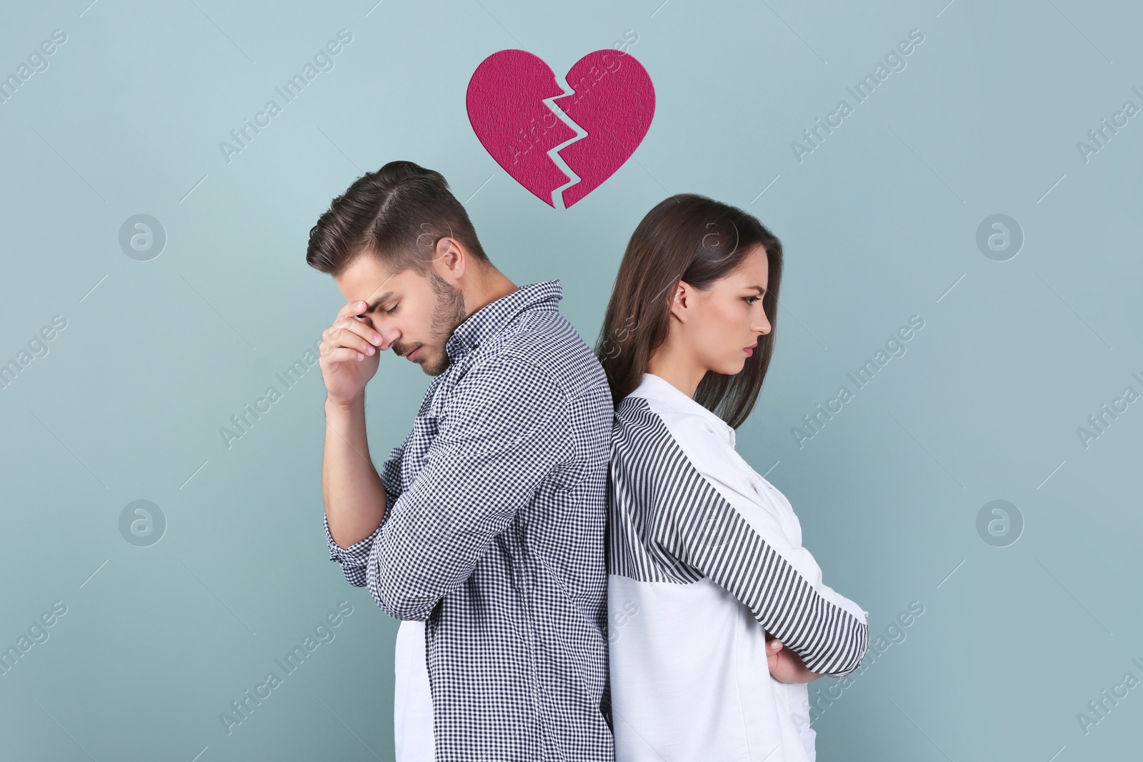 Image of Upset young couple and illustration of broken heart on color background. Relationship problems