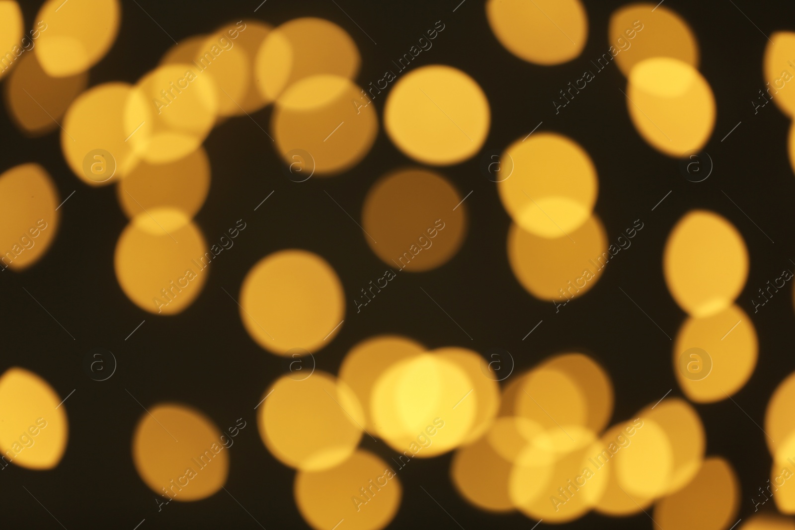 Photo of Beautiful golden lights on dark background. Bokeh effect