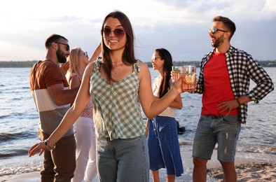 Photo of Woman with friends having fun near river at summer party