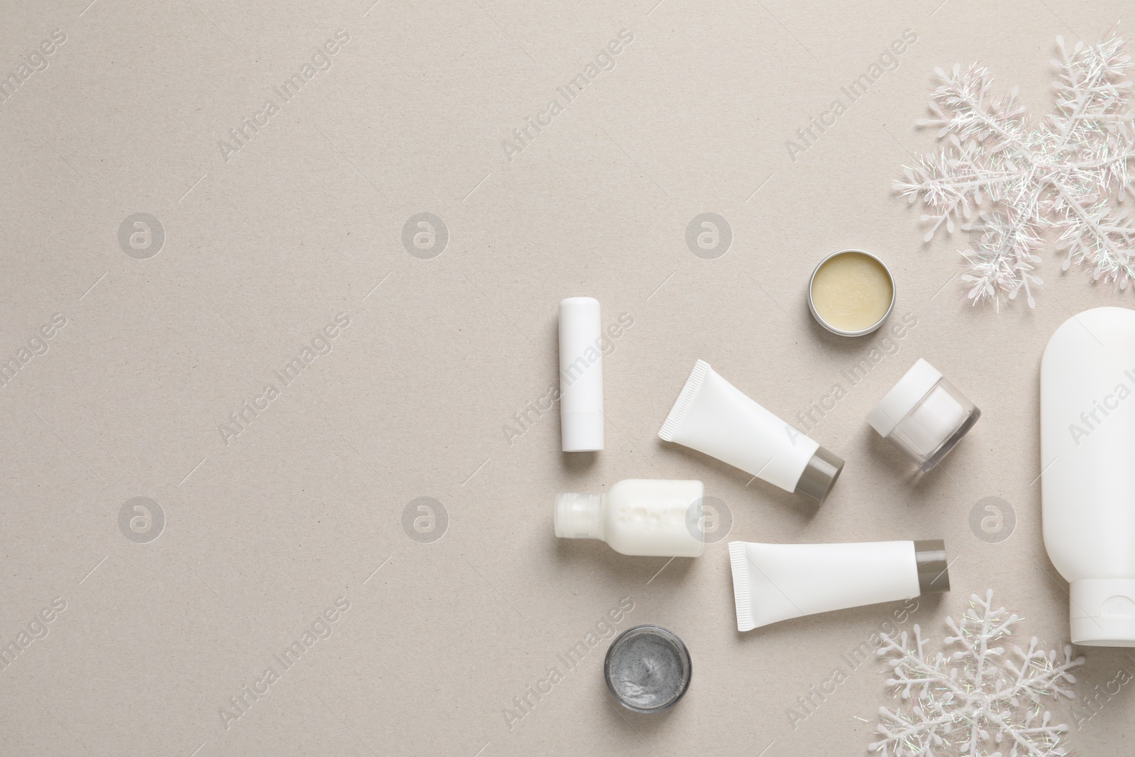 Photo of Set of cosmetic products on gray background, flat lay. Winter care