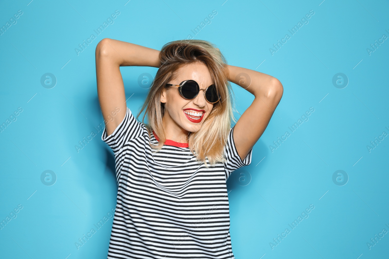 Photo of Beautiful young woman with healthy long blonde hair on color background