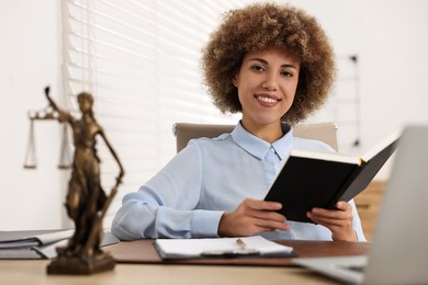 Photo of Happy notary with notebook at workplace in office