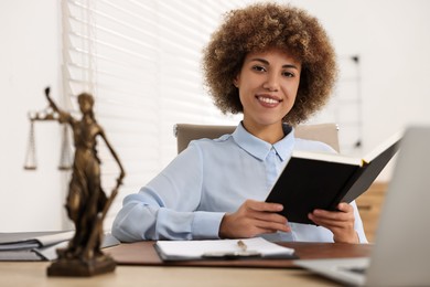 Happy notary with notebook at workplace in office